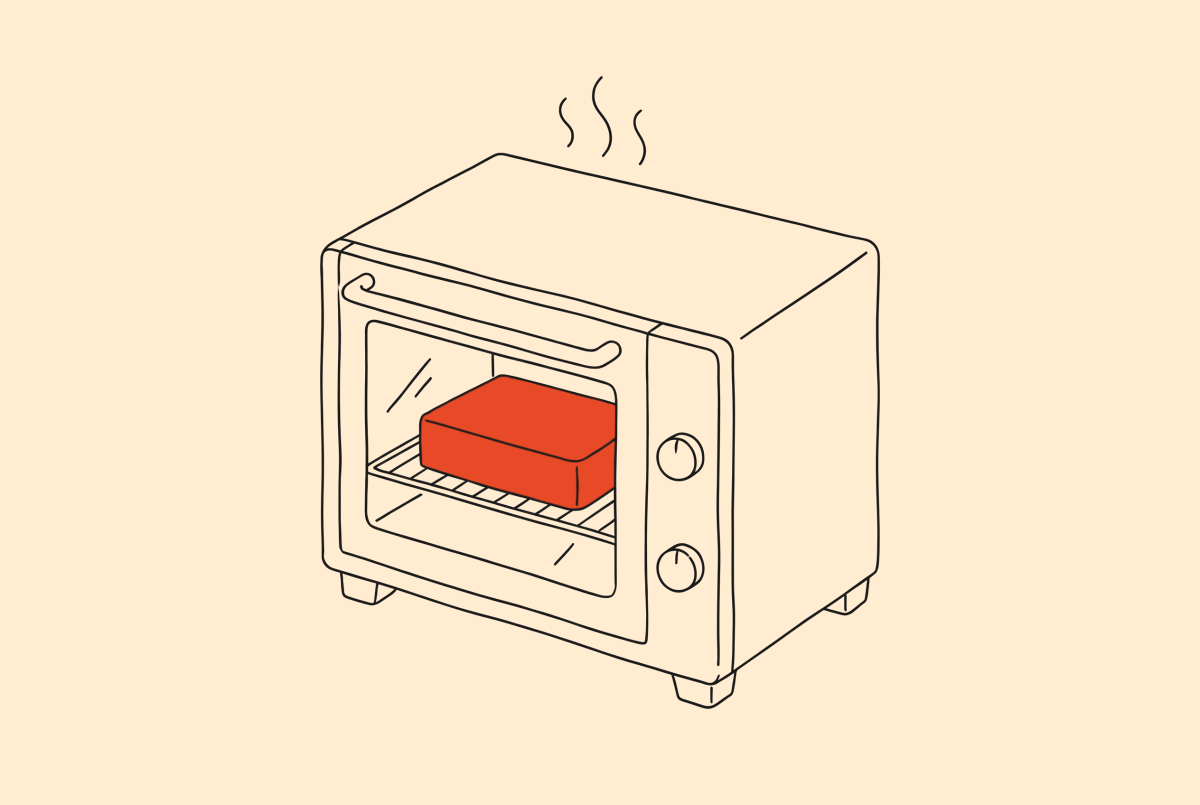 An oven with the cake behind the door window.